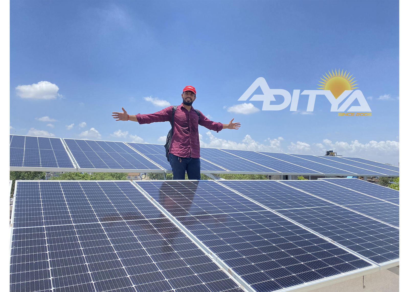 Man Standing near Solar panels showing his passion for Solar